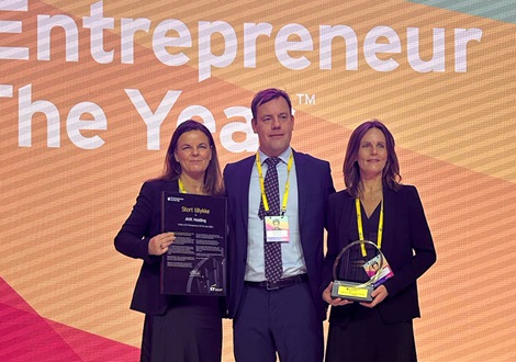 Anne-Mette Kjær, Jacob Kjær and Pernille Kjær receiving the EY award